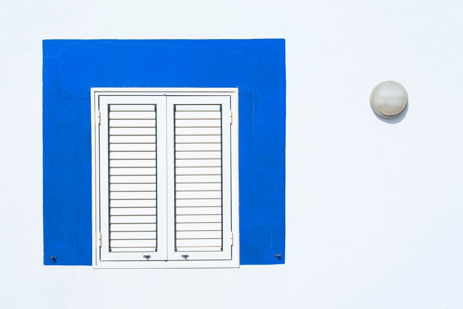 White plantation shutters on home windows